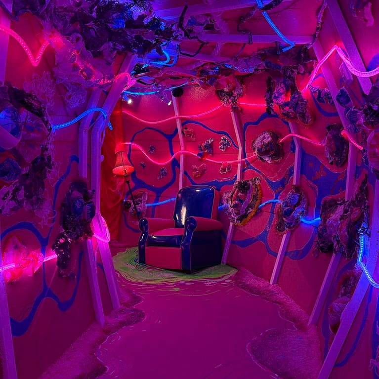 Pink Hallway with Multicolor LED Lights and a Chair