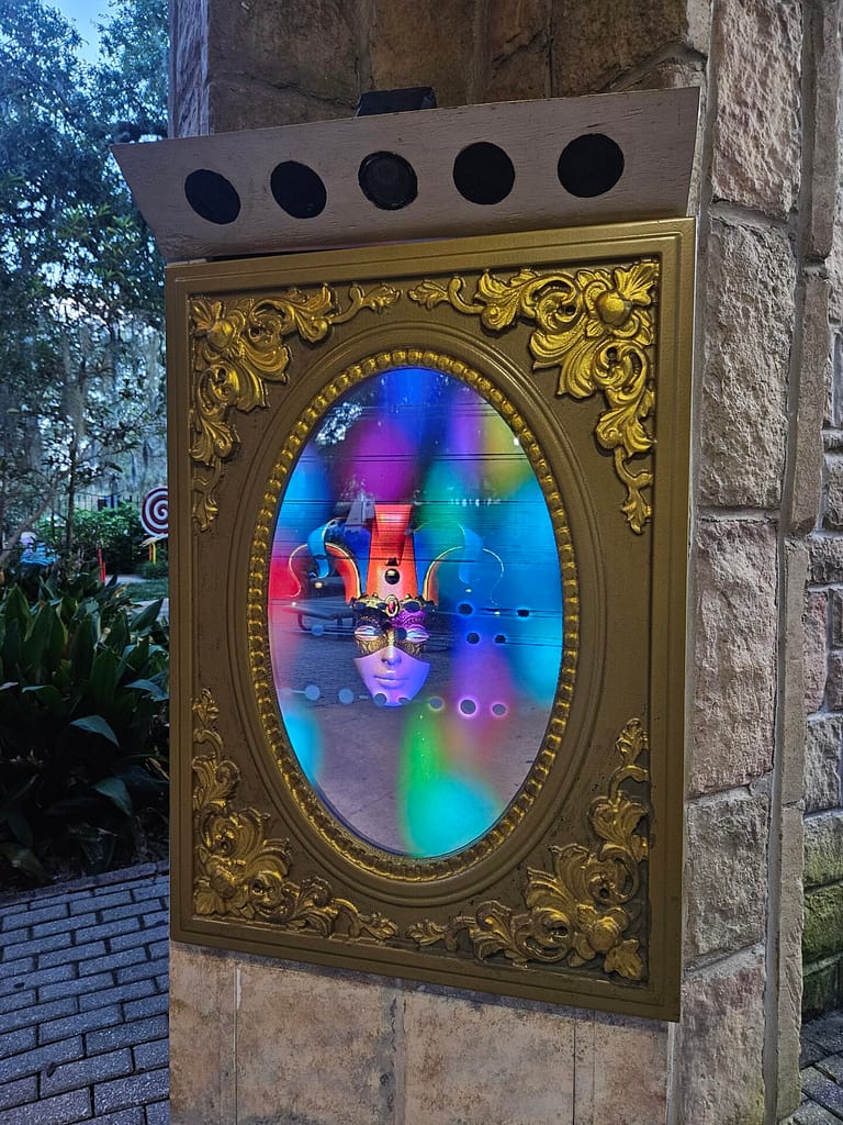 Magic mirror showing reflective mirror with jester face and colors on screen