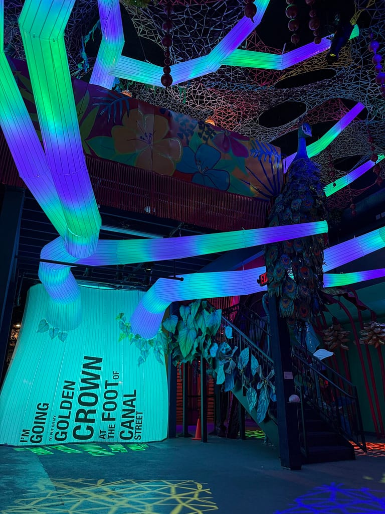 Inflatable tree with multiple branches lit with purple and green lighting