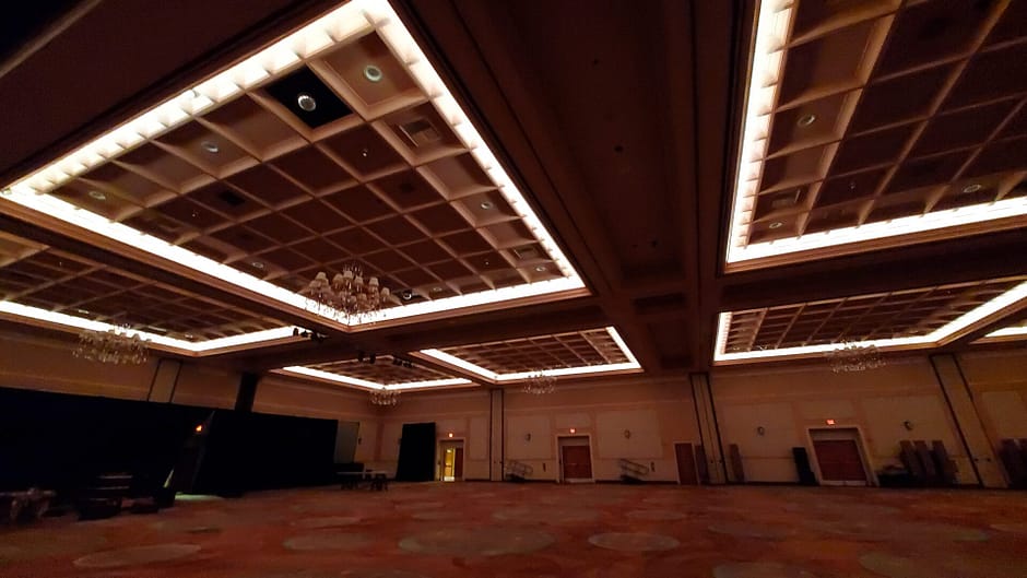 Conference room ceiling lit up in brown lighting