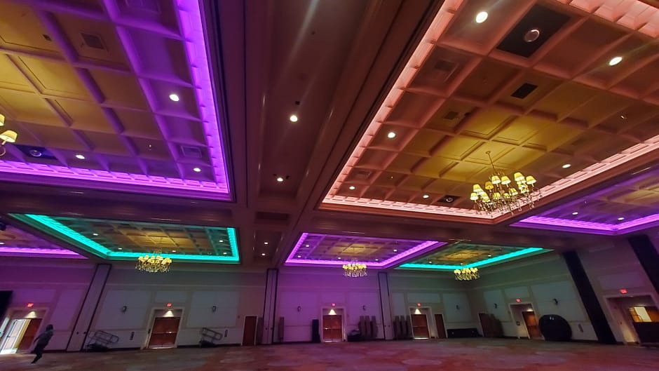 Conference room ceiling lit up in multiple colors