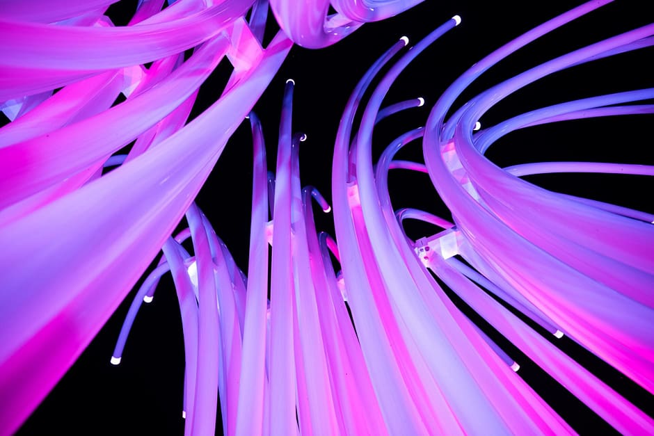 Art installation of light up PVC tubes glowing in purple