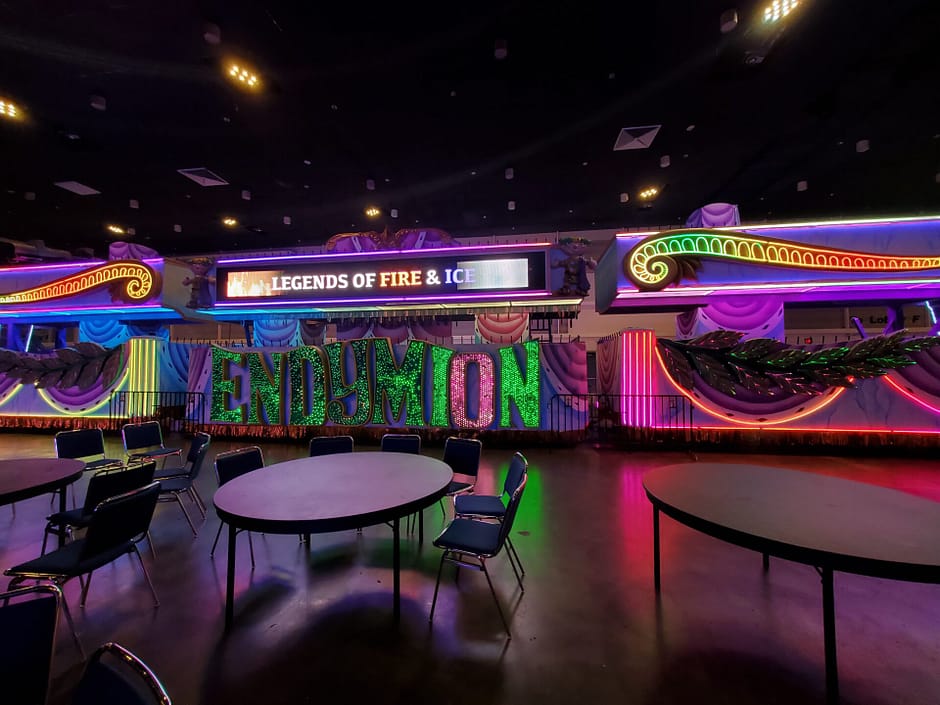 Mardi gras floats with Endymion lit up in green and purple and float decor lit up in multiple colors