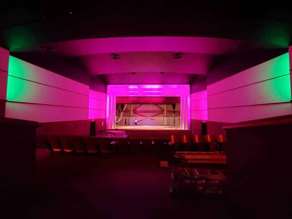 Auditorium with Pink and Green Lighting