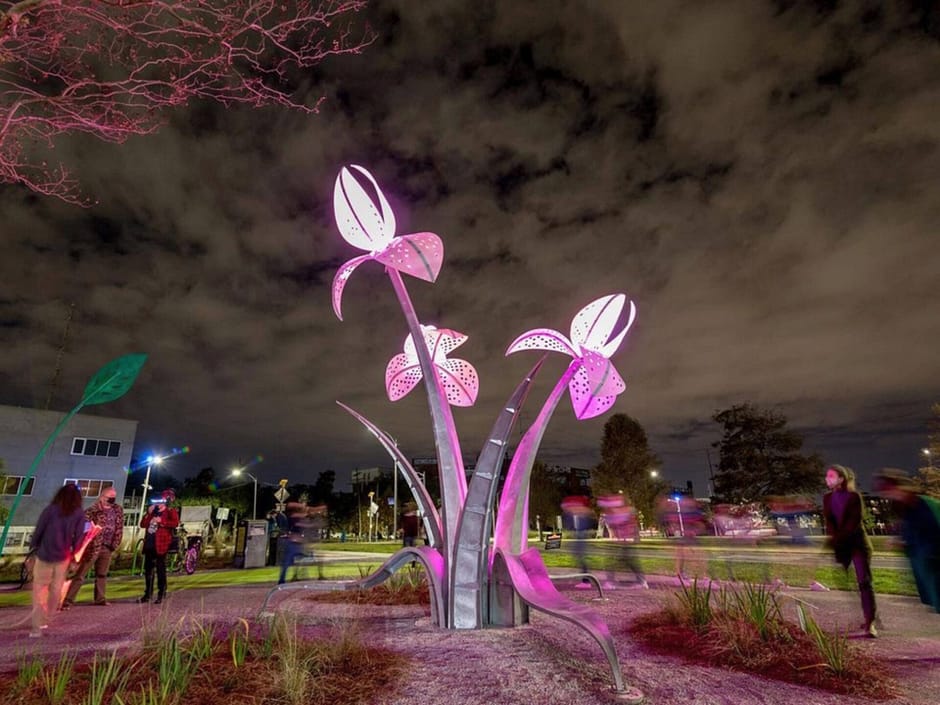 Flower sculpture lit up with purple lighting